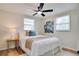 Cozy bedroom featuring neutral tones, a ceiling fan, and a view of the window at 10408 118Th Ave, Largo, FL 33773