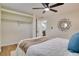 Bedroom with open closet shelves and a modern light fixture at 10408 118Th Ave, Largo, FL 33773