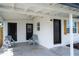 Covered front porch featuring chairs and an entrance to the home at 10408 118Th Ave, Largo, FL 33773