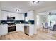 Modern kitchen featuring white cabinets, stainless steel appliances, and a stylish tile backsplash at 10408 118Th Ave, Largo, FL 33773