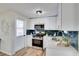 Bright kitchen with white cabinets, stainless steel appliances, and stylish subway tile backsplash at 10408 118Th Ave, Largo, FL 33773