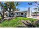 Serene backyard featuring a manicured lawn, patio, and mature trees, creating a peaceful retreat at 11490 48Th N Ave, St Petersburg, FL 33708