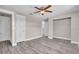 Bedroom with a ceiling fan, vinyl flooring, and a spacious closet at 11490 48Th N Ave, St Petersburg, FL 33708