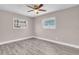 Bedroom featuring two windows and vinyl floors at 11490 48Th N Ave, St Petersburg, FL 33708