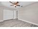 Bedroom with a ceiling fan, vinyl flooring, and a spacious closet at 11490 48Th N Ave, St Petersburg, FL 33708