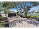 Charming single-story home featuring a brick driveway, mature trees, and a two-car garage at 11490 48Th N Ave, St Petersburg, FL 33708