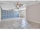 Spacious garage with a ceiling fan, tiled floor, and an overhead door at 11490 48Th N Ave, St Petersburg, FL 33708