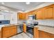 Modern kitchen featuring stainless steel appliances, granite countertops, and wood cabinetry at 11490 48Th N Ave, St Petersburg, FL 33708