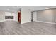 Open-concept living room with hardwood floors, neutral walls, and view of a fireplace and kitchen at 11490 48Th N Ave, St Petersburg, FL 33708
