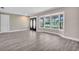 Bright living room featuring hardwood floors, a bay window, and a modern brick accent wall at 11490 48Th N Ave, St Petersburg, FL 33708
