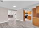 Spacious living area showcasing hardwood floors, a kitchen view, and a cozy fireplace at 11490 48Th N Ave, St Petersburg, FL 33708