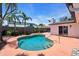 Beautiful kidney shaped pool with a concrete surround framed by palm trees and lush foliage, creating a private oasis at 11490 48Th N Ave, St Petersburg, FL 33708