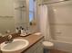 Well-lit bathroom featuring a shower-tub combo and neutral color scheme at 11513 Andy Dr, Riverview, FL 33569