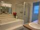 Bright bathroom with separate soaking tub and glass-enclosed shower at 11513 Andy Dr, Riverview, FL 33569