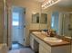 Double vanity bathroom featuring two sinks and separate shower room at 11513 Andy Dr, Riverview, FL 33569