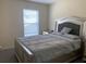 Comfortable bedroom with a stylish bed, matching nightstand, and a bright window providing natural light at 11513 Andy Dr, Riverview, FL 33569