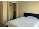 Bedroom with a minimalist design, featuring a bed, closet, and a window providing natural light at 11513 Andy Dr, Riverview, FL 33569