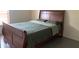 Bedroom with a dark wood bed frame and window letting in natural light at 11513 Andy Dr, Riverview, FL 33569
