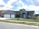 Lovely single-story home with a two-car garage, lush lawn, and a welcoming front entry at 11513 Andy Dr, Riverview, FL 33569