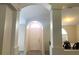 Inviting foyer featuring an arched entrance, columns, and a view into the dining area and other living spaces at 11513 Andy Dr, Riverview, FL 33569