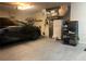 Two car garage space providing ample storage, shelving and appliances, and features a black car at 11513 Andy Dr, Riverview, FL 33569