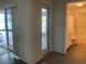 Hallway leading to a bathroom and outdoor area, featuring neutral walls and tile flooring at 11513 Andy Dr, Riverview, FL 33569