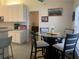 Bright kitchen featuring white cabinets, granite countertops, and a breakfast nook with a glass-top table at 11513 Andy Dr, Riverview, FL 33569