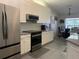 Bright kitchen featuring white cabinets, stainless steel appliances, and an adjacent dining area for convenient meals at 11513 Andy Dr, Riverview, FL 33569