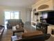 Comfortable living room with entertainment center, fireplace, and sliding glass door at 11513 Andy Dr, Riverview, FL 33569