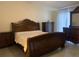 Well-lit main bedroom with ornate bed frame and matching bedroom furniture at 11513 Andy Dr, Riverview, FL 33569