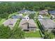 Serene aerial shot of home highlighting backyard with fence, lawn, and scenic lake backdrop at 1342 Salmonberry St, Wesley Chapel, FL 33543