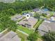 Beautiful aerial view of this home's backyard, fence, and lush surrounding landscaping with a lake nearby at 1342 Salmonberry St, Wesley Chapel, FL 33543