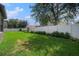 Beautiful backyard features manicured lawn, privacy fence, landscaping and mature trees at 1342 Salmonberry St, Wesley Chapel, FL 33543