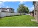 Lush backyard featuring a well-maintained lawn and white vinyl fence for privacy at 1342 Salmonberry St, Wesley Chapel, FL 33543