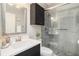 Modern bathroom featuring a walk-in shower with glass doors and a stylish vanity with dark wood accents at 1342 Salmonberry St, Wesley Chapel, FL 33543