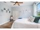 Cozy bedroom featuring a comfortable bed, light blue walls, and wood-look flooring at 1342 Salmonberry St, Wesley Chapel, FL 33543