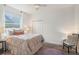 Bright bedroom with a large window, soft bedding, and dark furniture accents at 1342 Salmonberry St, Wesley Chapel, FL 33543