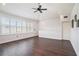 Well-lit bonus room featuring dark floors and windows with plantation shutters at 1342 Salmonberry St, Wesley Chapel, FL 33543