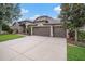 Charming single-story home with a three-car garage, featuring beautiful landscaping at 1342 Salmonberry St, Wesley Chapel, FL 33543