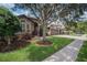 Well-maintained home featuring mature trees, lush landscaping, and a three-car garage at 1342 Salmonberry St, Wesley Chapel, FL 33543