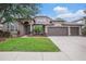 Charming single-story home with well-manicured lawn and a three-car garage and beautiful landscaping at 1342 Salmonberry St, Wesley Chapel, FL 33543