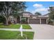 Beautiful home with a 3 car garage, a well-manicured lawn and mature trees at 1342 Salmonberry St, Wesley Chapel, FL 33543