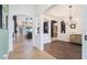 Hallway with archways leading to the dining room and living area, featuring hardwood and tile floors at 1342 Salmonberry St, Wesley Chapel, FL 33543