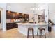 Open kitchen with granite countertops, stainless steel appliances, custom cabinets, and barstool seating at 1342 Salmonberry St, Wesley Chapel, FL 33543