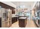 Open kitchen with granite countertops, stainless steel appliances, dark cabinetry and a kitchen island at 1342 Salmonberry St, Wesley Chapel, FL 33543