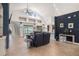Spacious living room with tile flooring, neutral decor, and sliding glass doors to the backyard at 1342 Salmonberry St, Wesley Chapel, FL 33543