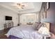Spacious main bedroom suite with hardwood floors, large bed, sitting area and natural light at 1342 Salmonberry St, Wesley Chapel, FL 33543