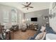 Bright home office with a vaulted ceiling, large windows, and a combination of hardwood and tile flooring at 1342 Salmonberry St, Wesley Chapel, FL 33543