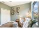 Stylish sitting room with natural light, closet, and a comfortable chair and ottoman at 1342 Salmonberry St, Wesley Chapel, FL 33543