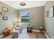 Cozy sitting room with a comfortable chair, ottoman, and views of the landscaped yard at 1342 Salmonberry St, Wesley Chapel, FL 33543